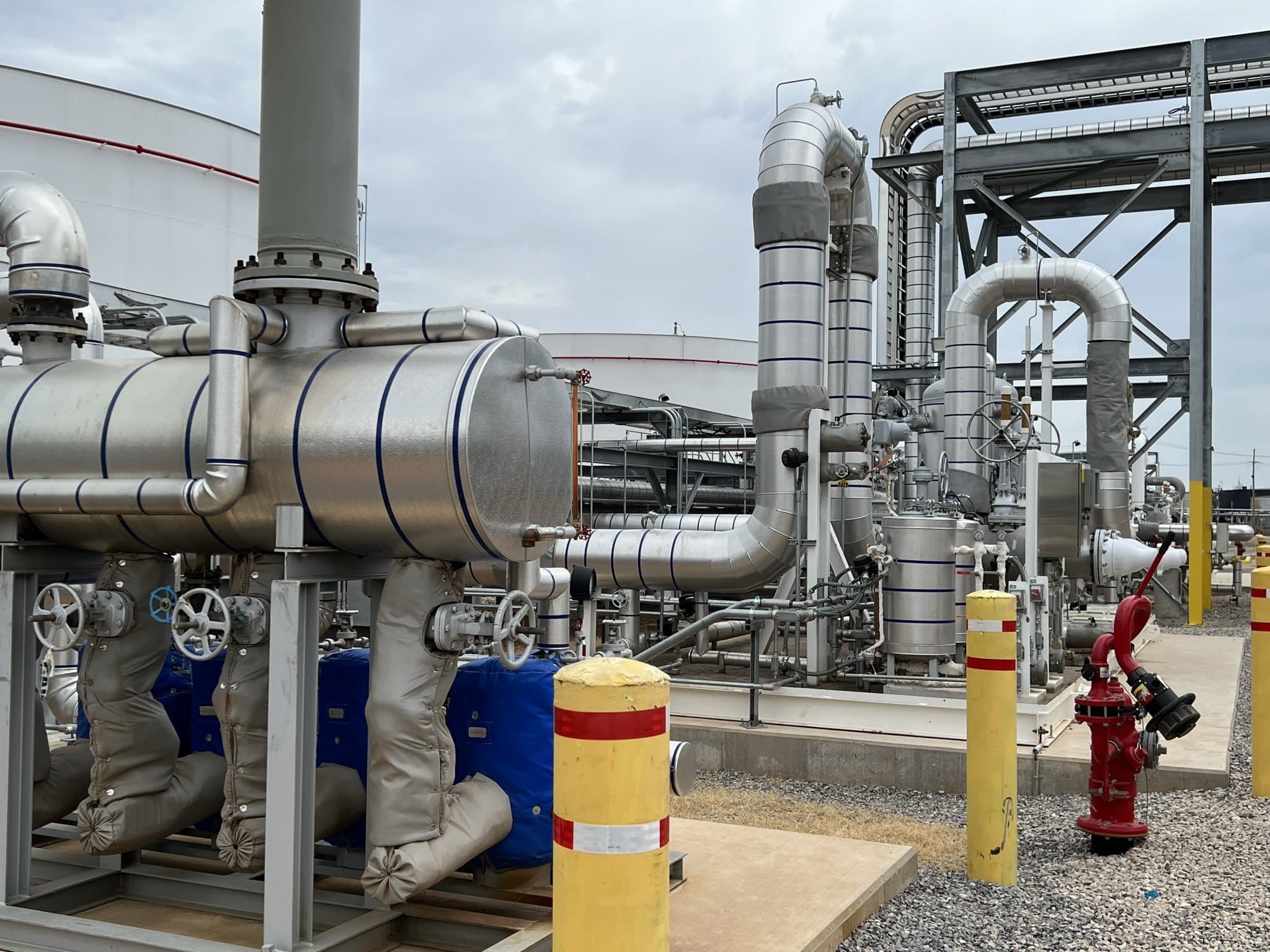 Insulated steam piping, heat exchangers, and valve stations on a plant skid.