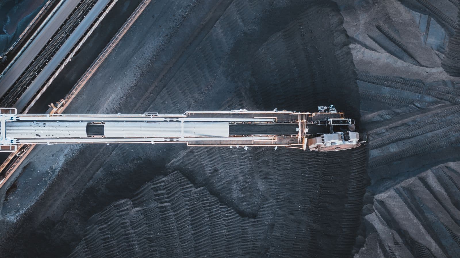 Industrial conveyor system moving bulk material, core ICPE territory.
