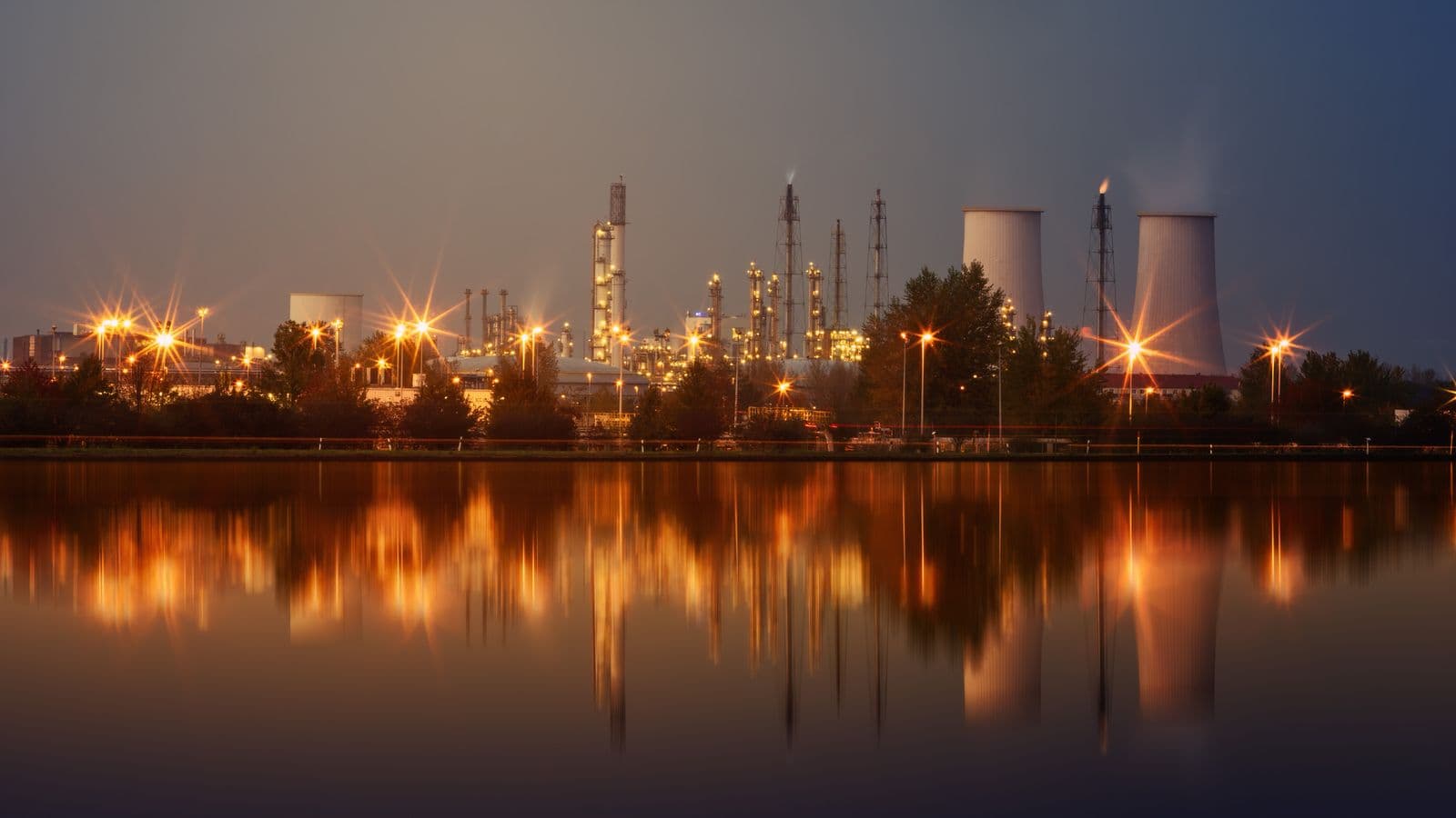 Large industrial facility at dusk with plant lighting, the scale ICPE serves.