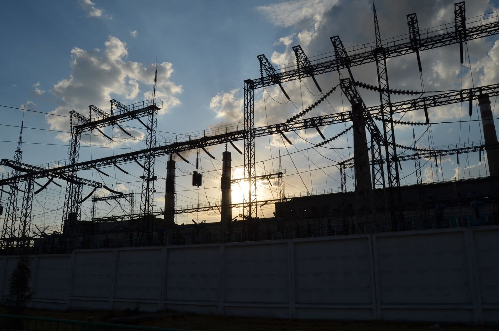 A high-voltage substation silhouetted at sunrise, the kind of facility ICPE engineers design.