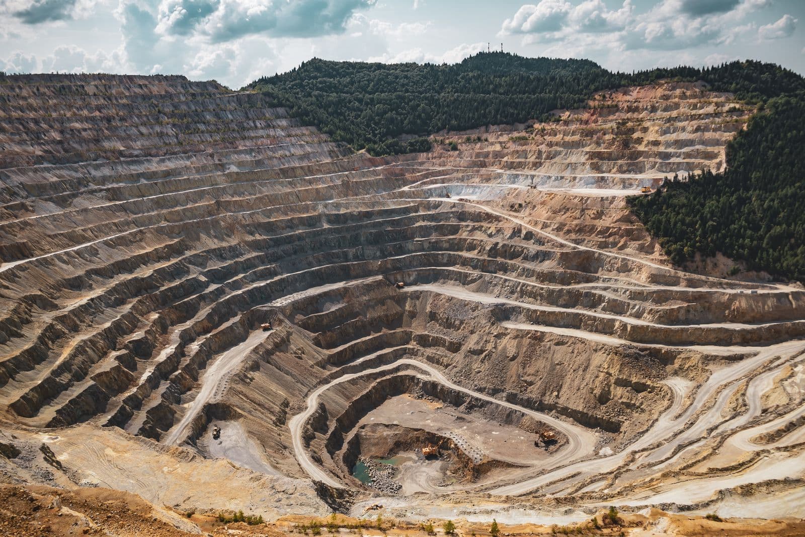 Aerial view of a terraced open-pit mine, the scale of operation ICPE engineers for.