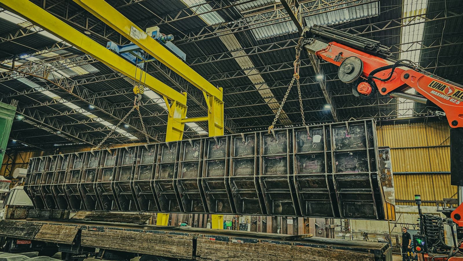 A crane rigging heavy machinery for relocation.