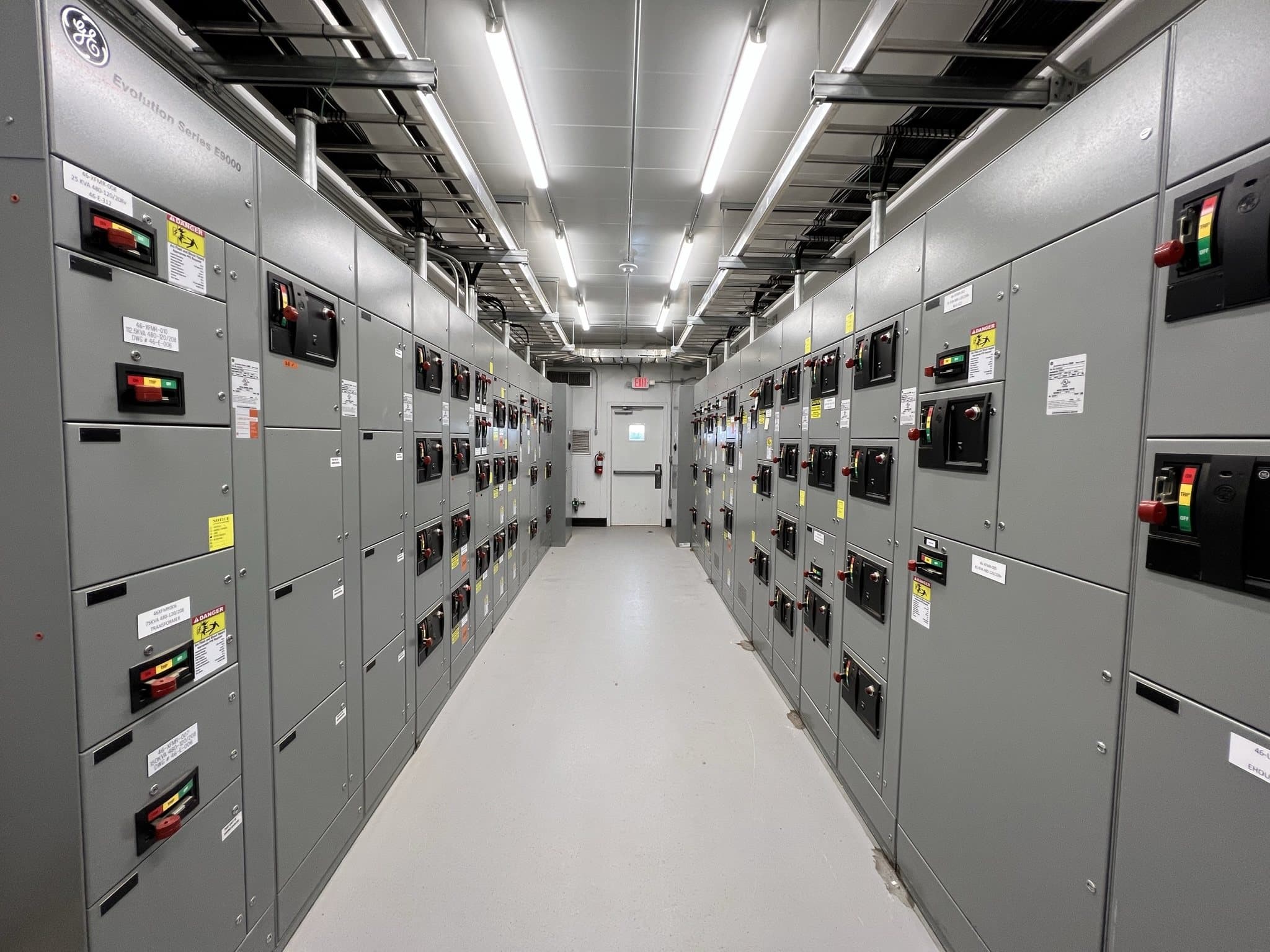 A lineup of motor control centers and low-voltage switchgear in a plant electrical room.