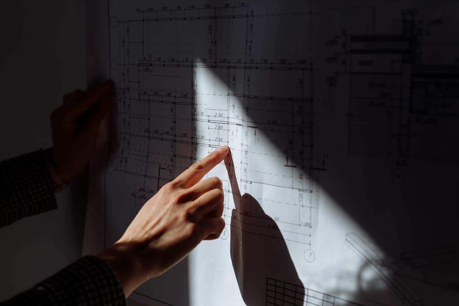 Construction drawings spread on a site table.