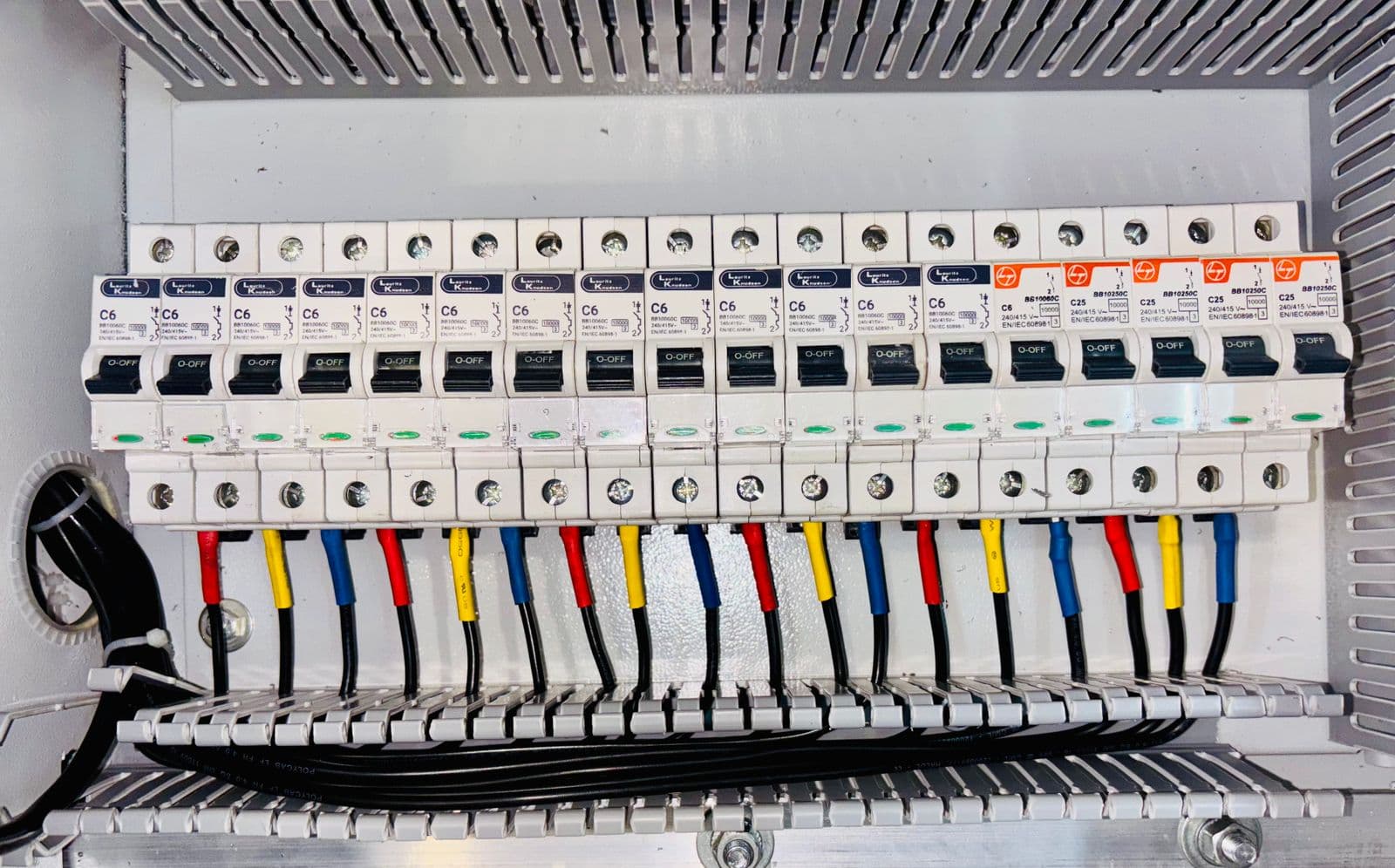 Protection and control panels with relays and indicator lights.
