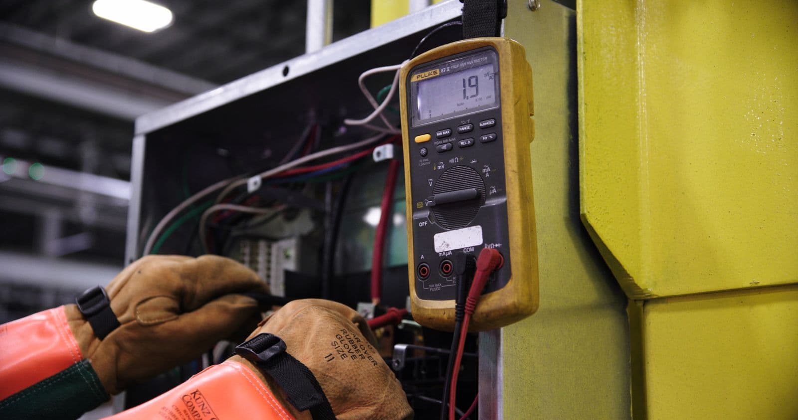 Electrical test equipment connected to a panel during commissioning.
