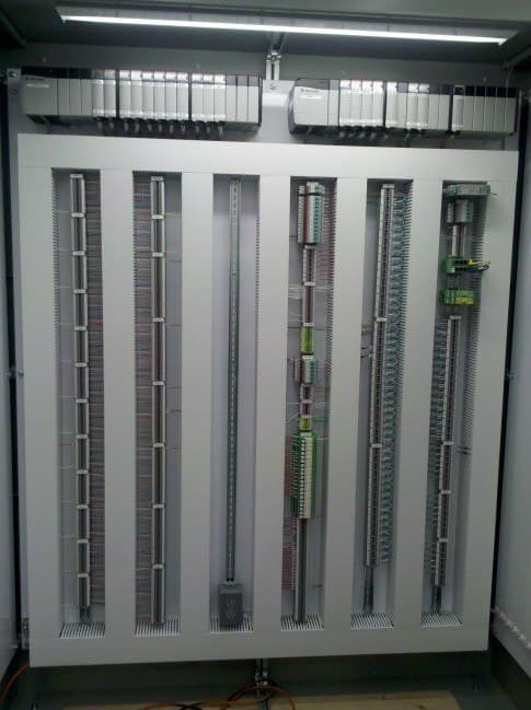 An open control panel with terminal strips and wiring duct.